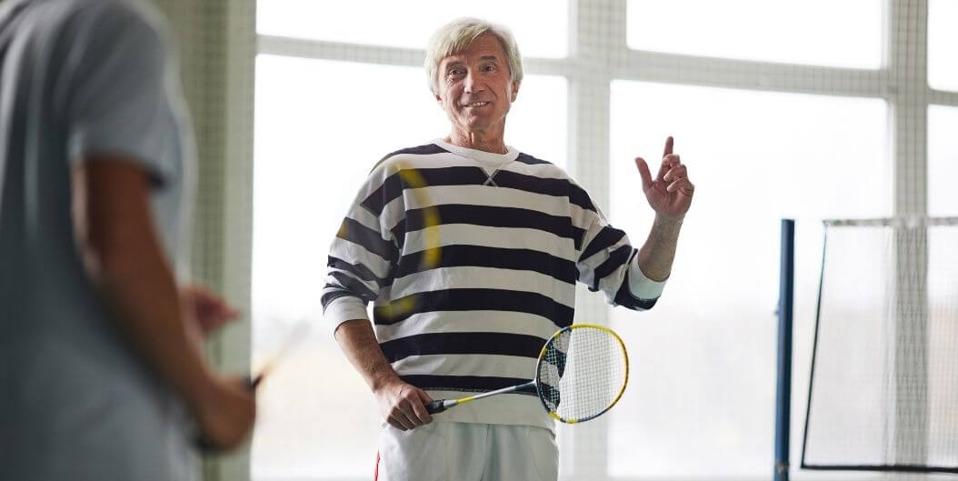 Senior Man Holding a Badminton Rocket At An Independent Living Facility