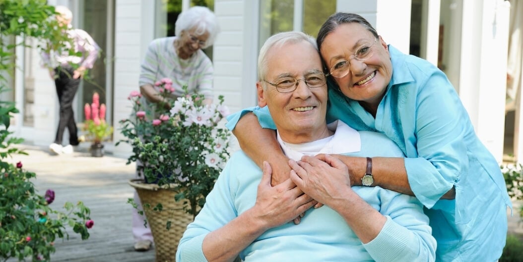 Senior Couple Enjoying Time Together in a Garden at an Independent Living Facility.