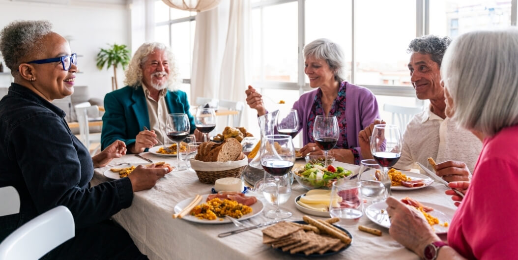Group of Seniors Sharing a Communal Meal Indoors at an Assisted Living Facility