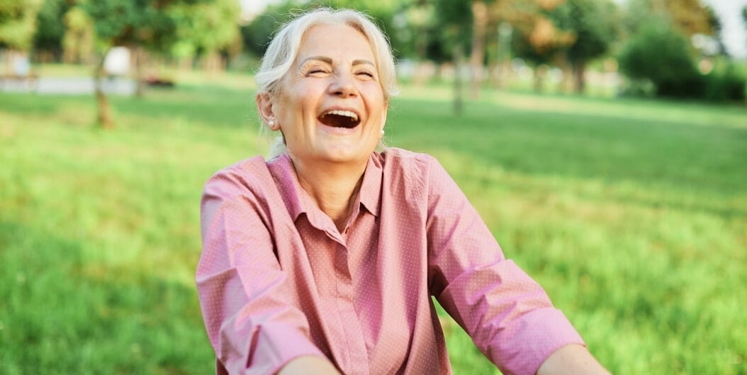 Elderly Woman Laughing Outdoors at Independent Living Facility